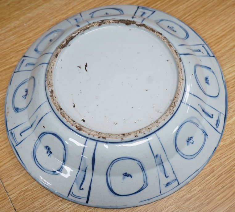 A 17th century Chinese blue and white ‘Kraak’ ware dish together with a Japanese celadon ground ‘dodo’ dish, initialled SGR, 33cm. Condition - fair